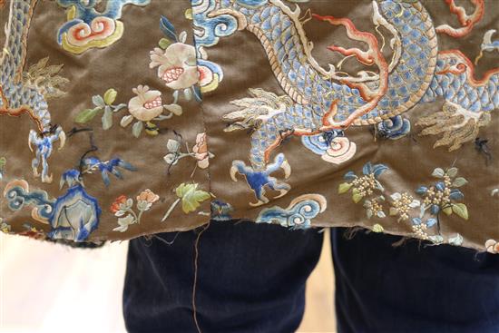 A Chinese black ground polychrome silk embroidered robe (a.f.)